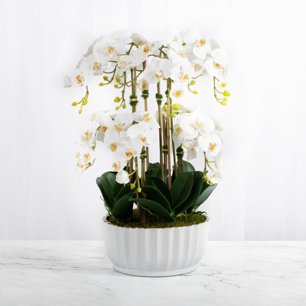 Faux orchid centerpiece in white vase