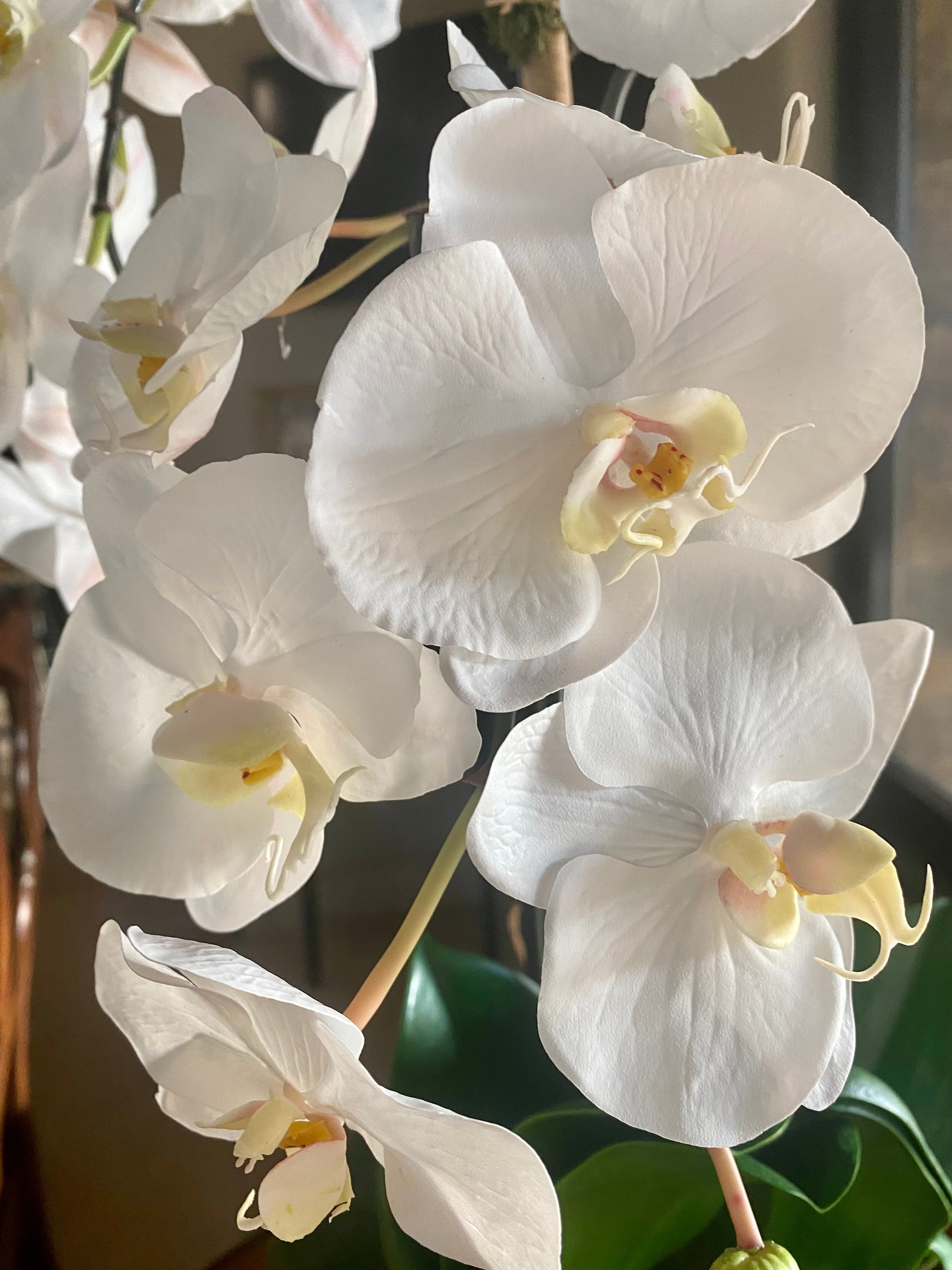 Faux orchid centerpiece in white vase